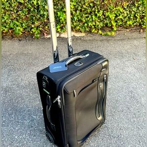 Tumi carry-on roller luggage. Black leather, excellent condition.